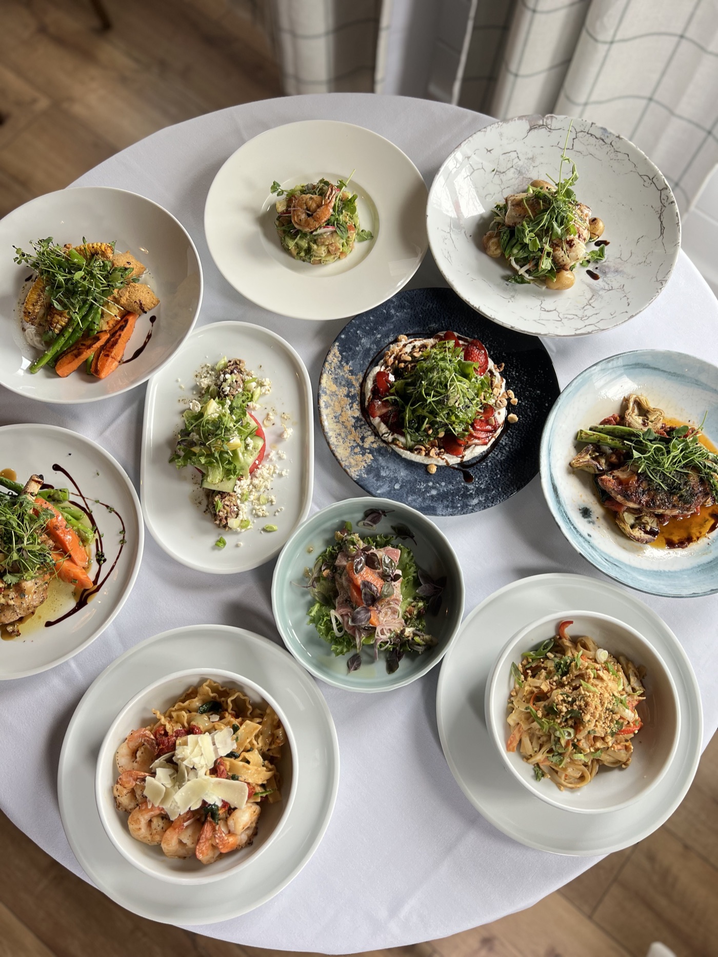 An overhead spread of plated dishes at Crossroads